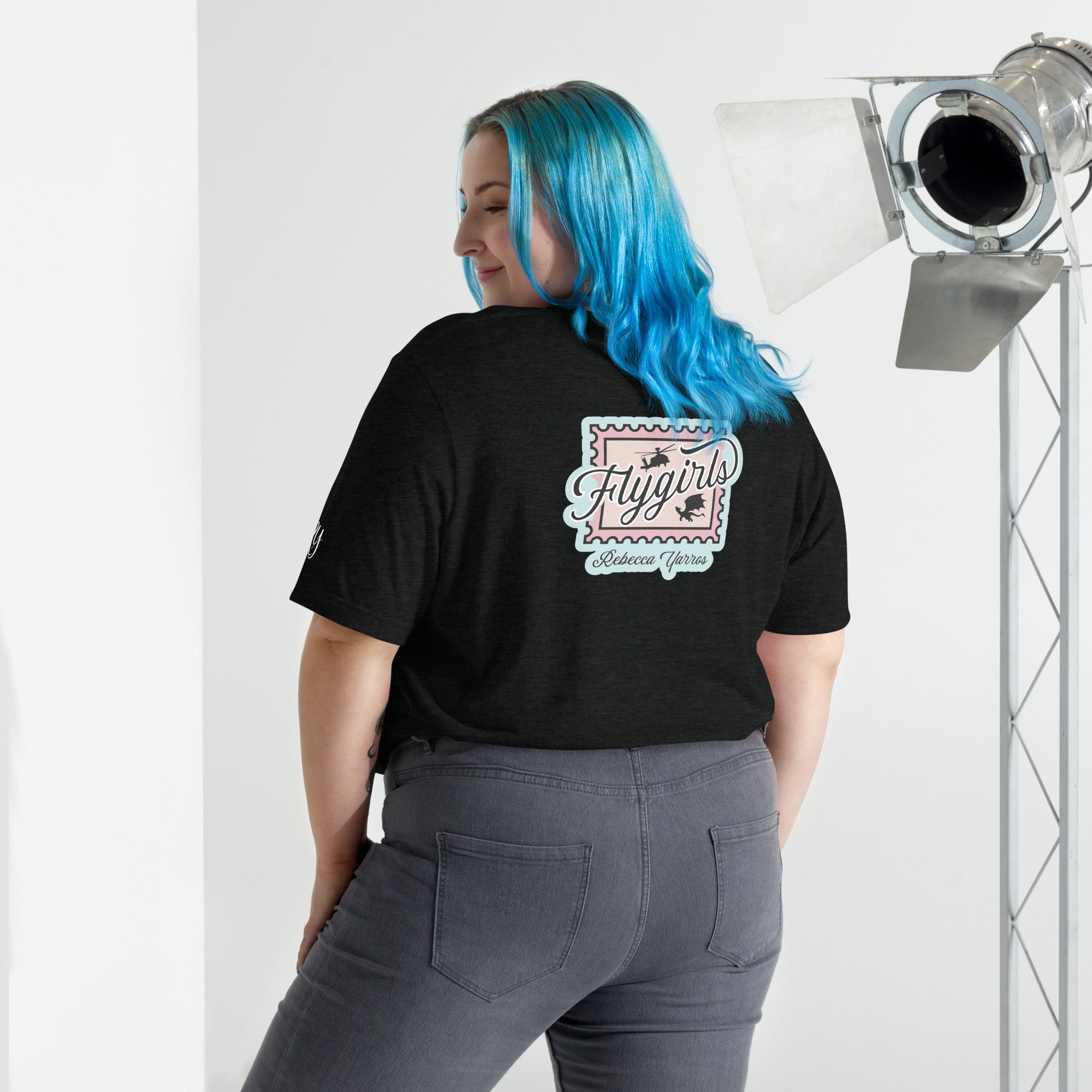 Woman wearing a black shirt with Flygirls stamp design on the back